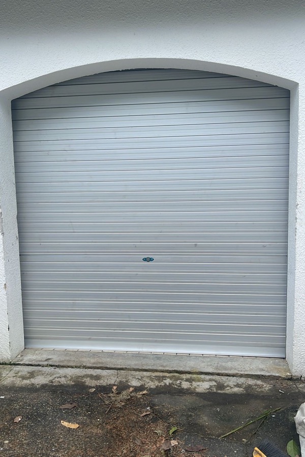 Roller shutter fitted within an arched garage opening