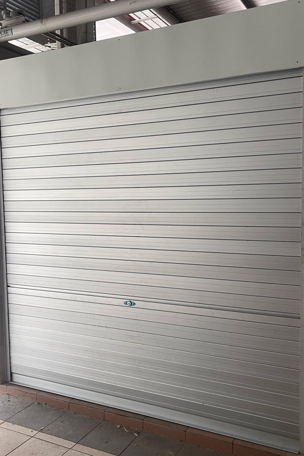 Motorised roller shutter at a commercial opening