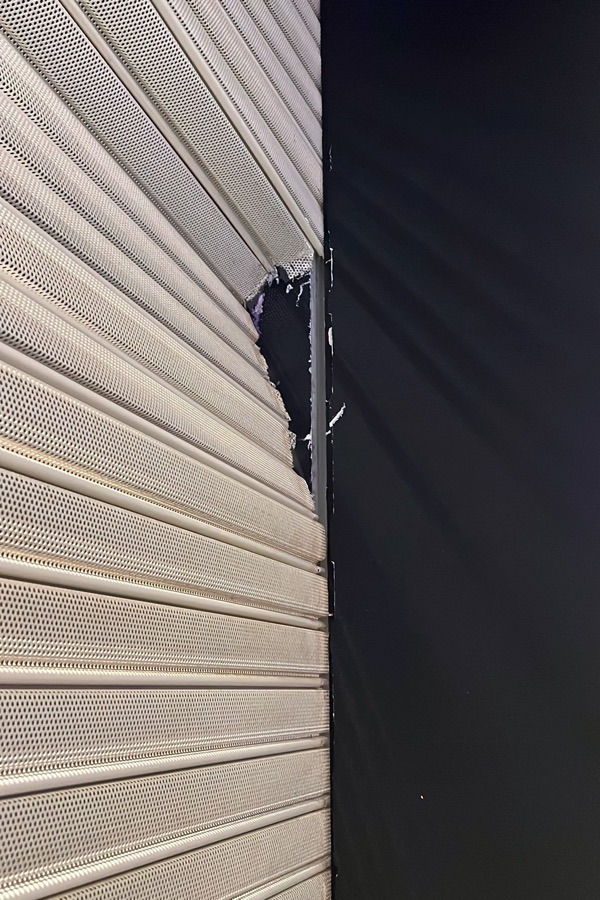 Damaged perforated roller shutter curtain